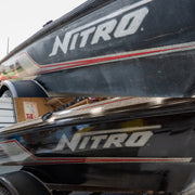 Nitro bass boat hull before and after Re-Gel gelcoat restoration showing faded oxidized finish restored to deep glossy black