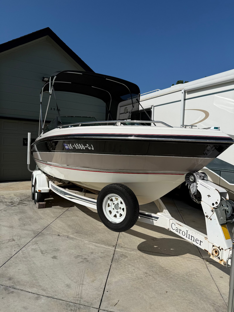 Caroliner boat with deep glossy black hull restored using Re-Gel wipe-on gelcoat restoration system