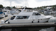 White Bayliner cabin cruiser with a glossy, restored hull docked at a marina after Re-Gel gelcoat restoration.