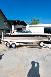 Chaparral boat with restored glossy black and white hull after Re-Gel gelcoat restoration treatment
